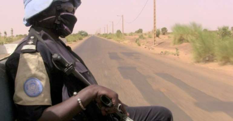 Peacekeepers (similar to this one, pictured May 2016) travelling the road linking the central town of Douentza to the city of Timbuktu further north hit a roadside bomb, according to a statement from the MINUSMA peacekeeping mission. By SOULEYMANE AG ANARA (AFP/File)
