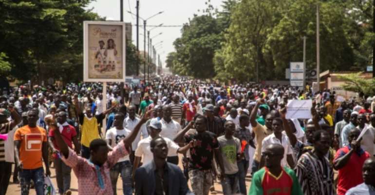 People gather during a rally in the Burkinabe capital Ouagadougou in the first large protest by opposition supporters against the current government's policy since the election of President Kabore in November 2015. By OLYMPIA DE MAISMONT (AFP)