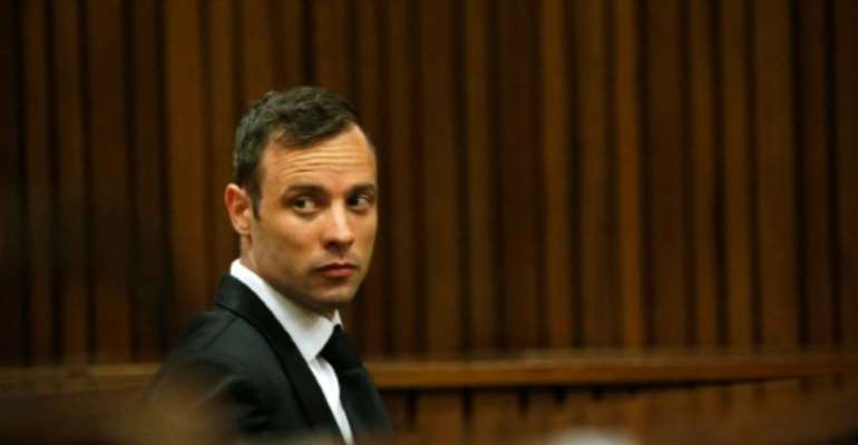 The South African High Court found former paralympian Oscar Pistorius guilty of murdering his girlfriend Reeva Steenkamp in 2013, overturning his earlier conviction on the lesser charge of culpable homicide. By Siphiwe Sibeko (POOL/AFP/File)