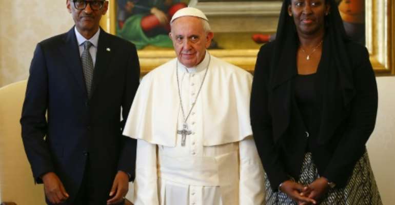 Pope Francis (centre) poses with Rwanda's President Paul Kagame and his wife Jeannette Kagame ahead of a meeting at the Vatican March 20, 2017. By TONY GENTILE (POOL/AFP)