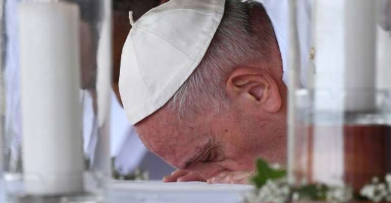 Pope Francis kissed the altar before leading the mass. By Tiziana FABI (AFP/File)