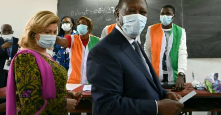 President Alassane Ouattara, shown here voting with his wife, won with more than 94 percent of the vote. By Issouf SANOGO (AFP/File)