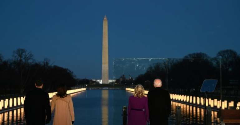 President-elect Joe Biden (R) and incoming First Lady Jill Biden watch as a Covid-19 memorial is lit in Washington, DC. By Jim WATSON (AFP)