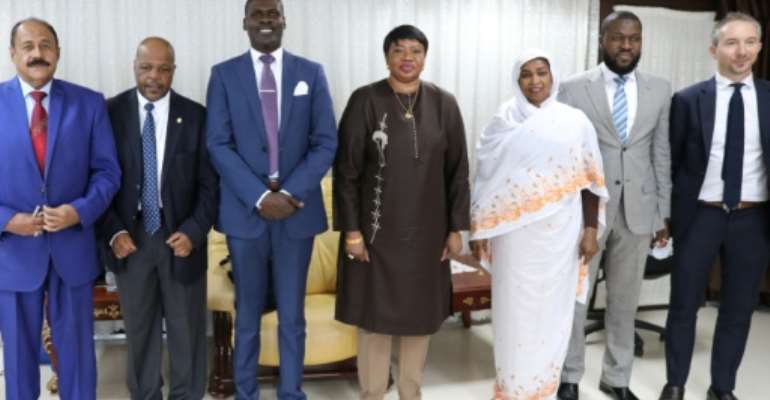 Prosecutor of the International Criminal Court, Fatou Bensouda (C), poses with Sudanese officials, including Justice Minister Nasruddin Abdel Bari (3rd L), during her visit to Khartoum. By - (AFP)
