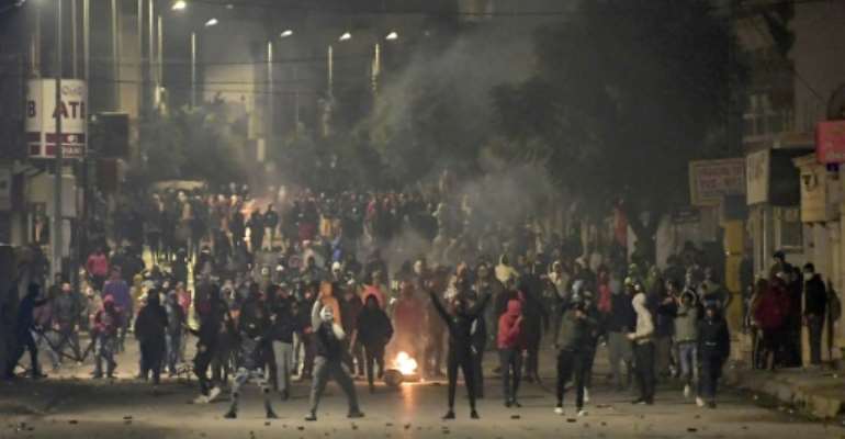 Protesters in Tunisia clashed with police in the Ettadhamen suburb of Tunis on Tuesday night. By FETHI BELAID (AFP)