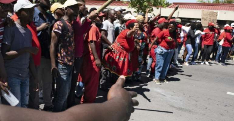Protesters outside a school in Cape Town where a whites-only party was allegedly organised last month. By RODGER BOSCH (AFP)