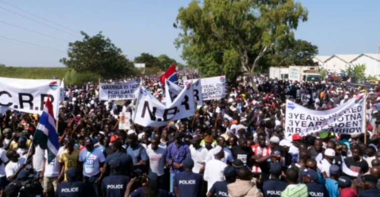 Protesters take part in a demonstration against Gambian President Adama Barrow, calling for him to keep his pledge to quit after three years in office. By Romain CHANSON (AFP)