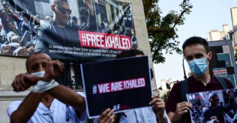 Protesters take part in an RSF-backed demonstration in support of jailed Algerian journalist Khaled Drareni on September 15 in Paris. By MARTIN BUREAU (AFP)
