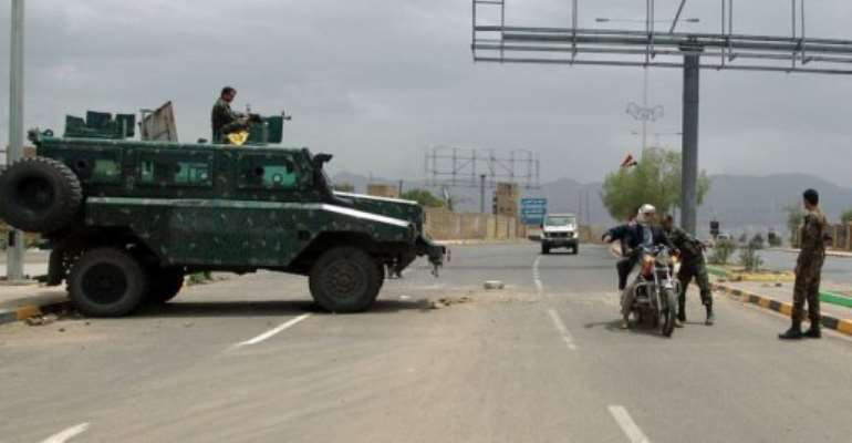 Yemeni soldiers search a motorbike at a checkpoint on a street leading to the US embassy in Sanaa on August 4, 2013. By Mohammed Huwais (AFP)