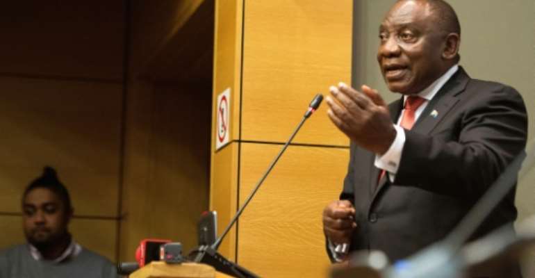 Ramaphosa, pictured meeting with young people at the South African parliament in Cape Town in June 2019. By RODGER BOSCH (AFP)