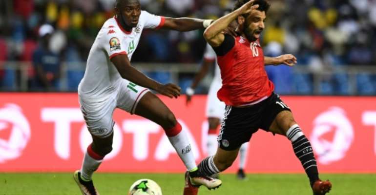 Renaissance Berkane defender Issoufou Dayo (L) challenges Mohamed Salah while playing for Burkina Faso against Egypt in a 2017 Africa Cup of Nations semi-final.. By GABRIEL BOUYS (AFP)