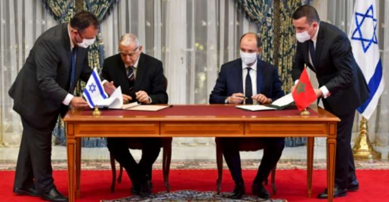 Representatives of Israel and Morocco sign landmark agreements at the Royal Palace in the Moroccan capital Rabat on December 22, 2020. By FADEL SENNA (AFP)