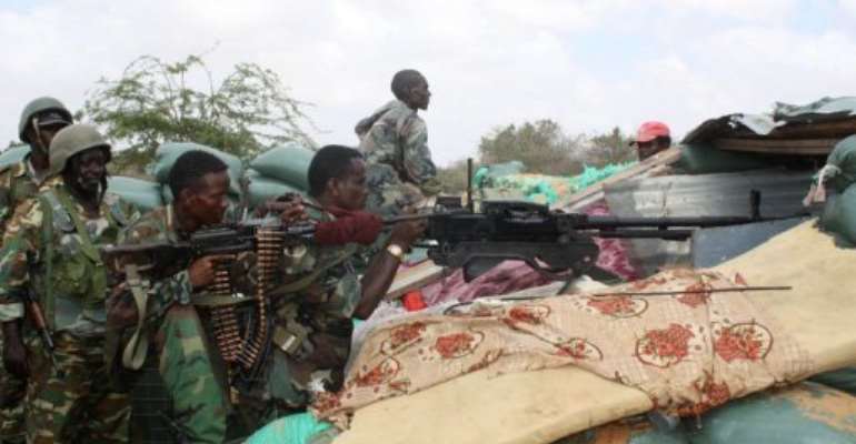 Somali military forces with African Union peacekeeping forces shoot at frontline of Deynille district. By Abdurashid Abdulle Abikar (AFP/File)