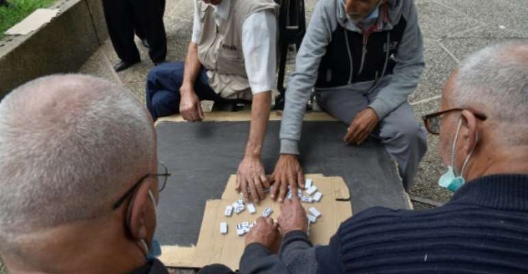 Retired Algerians play chess in a park in Bab El-Oued, a stronghold of the Hirak protest movement, as the country prepares to vote on constitutional changes. By RYAD KRAMDI (AFP)