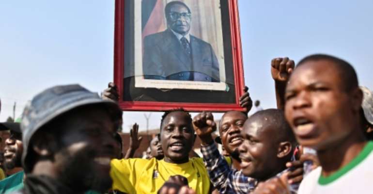 Robert Mugabe's death has left Zimbabweans torn over the legacy of the anti-colonial guerrilla hero whose iron-fisted rule ended in a coup in 2017. By TONY KARUMBA (AFP)