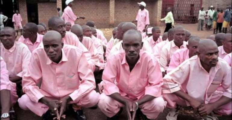 Prisoners in pink uniforms wait inside the prison of Gitarama to be transferred and attend a gacaca court session. By Thomas Lohnes (AFP/DDP/File)