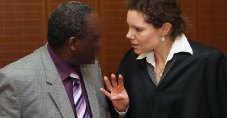 Former Rwandan mayor Onesphore Rwabukombe (L) talks with his lawyer, Natalie von Wistinghausen, as he arrives at court in Frankfurt, Germany, on January 18, 2011. By Daniel Roland (AFP/File)