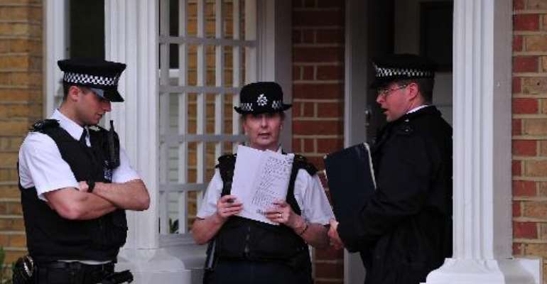 Police officers stand outside a house in New Malden, south London, on April 23, 2014 after three children were found dead at the house on the previous day. By Carl Court (AFP)