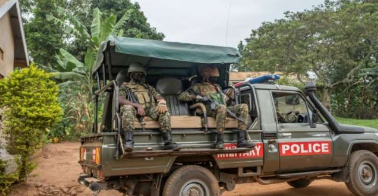 Security forces outside the house of Presidential candidate Bobi Wine on Saturday. By Sumy SADURNI (AFP)
