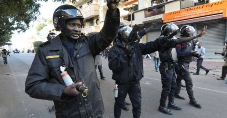Riot police launch tear gas canisters on Friday. By Seyllou (AFP/File)