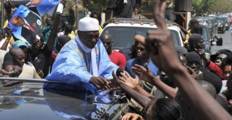 Senegalese President and presidential candidate Abdoulaye Wade greets supporters. By Issouf Sanogo (AFP)