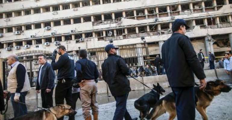 Police guard the scene of a car bomb explosion outside the Cairo police headquarters, on January 24, 2014. By Mahmoud Khaled (AFP/File)