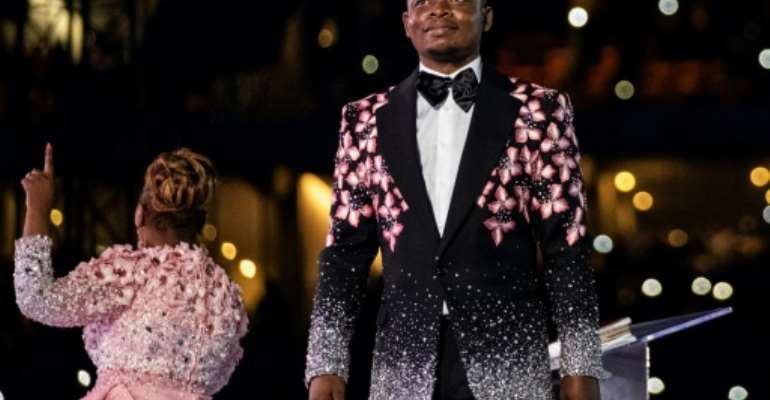 Shepherd Bushiri, seen here on stage with his wife, Mary Bushiri, at a stadium in Soweto on New Year's Day. By WIKUS DE WET (AFP)