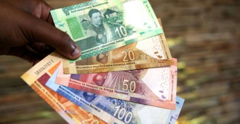 Show me the money: The jackpot was shared by 20 players who gambled on the uncanny sequence of numbers. By Phill Magakoe (AFP)