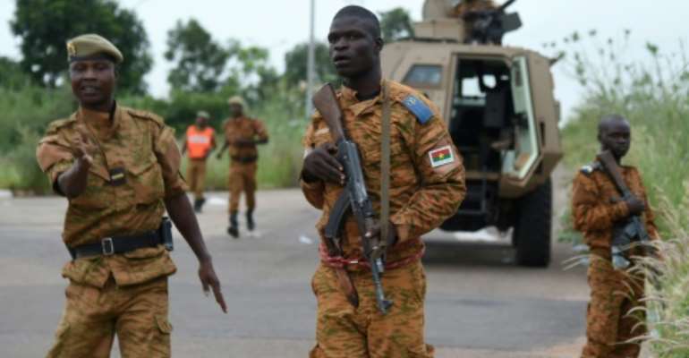 Soldiers loyal to Burkina Faso's government stand guard in Ouagadougou in September 2015 after an elite unit of presidential guards attempted to overthrow the country's transitional government. By SIA KAMBOU (AFP/File)