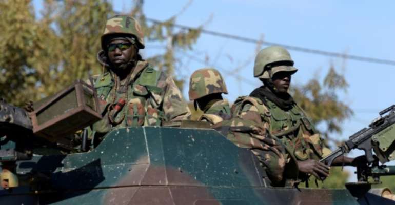 Soldiers patrol in the Gambian town of Soma on January 23, 2017. By SEYLLOU (AFP)