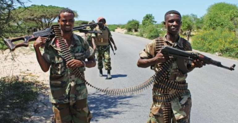 Somali soldiers patrol a stretch of road betwwen Mogadishu and Afgoye. By Mohamed Abdiwahab (AFP/File)