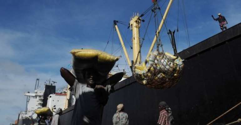 A Somalian porter carries a sack on April 24, 2013 in the sea port in Mogadishu. By Tony Karumba (AFP/File)