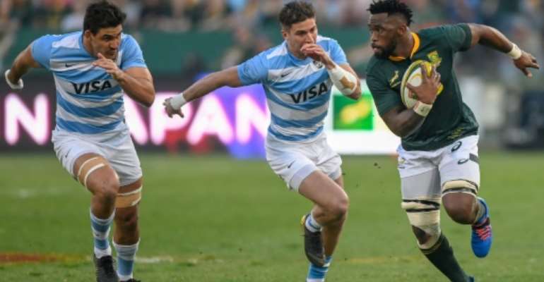 South Africa skipper Siya Kolisi (R) outpaces two Argentines during a Rugby World Cup warm-up match in Pretoria last month. By Christiaan Kotze (AFP)