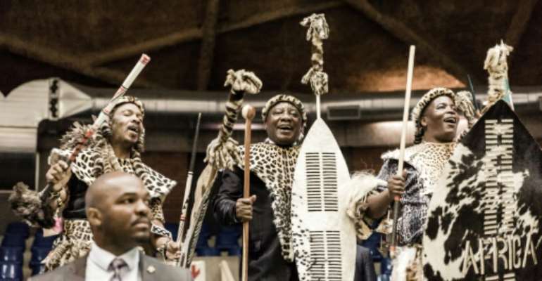South African President Cyril Ramaphosa dances with members of the Mkwanazi clan after symbolically handing back land to the community. By Rajesh JANTILAL (AFP)