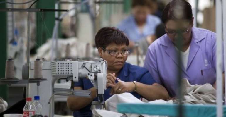 Seamstresses work at Peter Blond and Associates Clothing Factory in Elsiesriver, Cape Town. By Rodger Bosch (AFP/File)