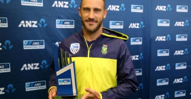 South Africa's captain Faf du Plessis holds the trophy on the day five of their third Test match against New Zealand, after the last day's play was called off due to rain, at Seddon Park in Hamilton, on March 29, 2017. By Michael Bradley (AFP)