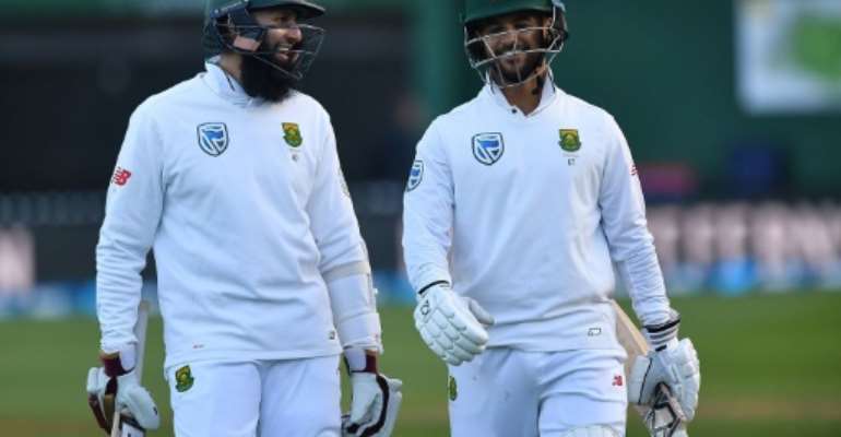 South Africa's Hashim Amla (L) and Jean-Paul Duminy celebrate after winning their 2nd Test against New Zealand, at the Basin Reserve in Wellington, on March 18, 2017. By Marty Melville (AFP)