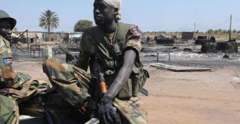 South Sudan's former rebel army the Sudan People's Liberation Army (SPLA) soldiers sit in a pick-up in the key north oil city of Bentiu after capturing it from rebels on January 12, 2014. By Simon Maina (AFP/File)