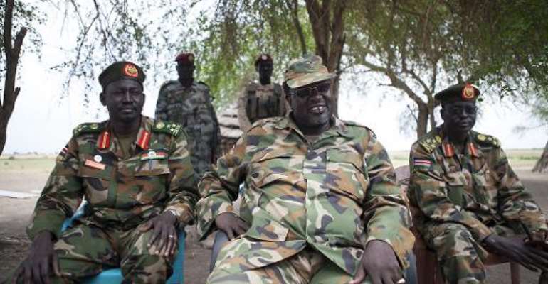 South Sudanese rebel leader and former vice president Riek Machar (centre) attends an interview in Nasir, on April 14, 2014. By Zacharias Abubeker (AFP)