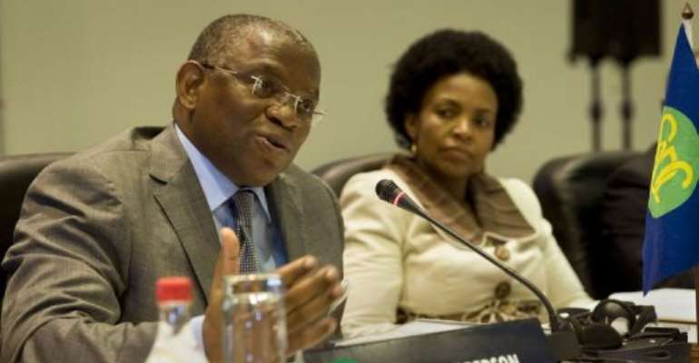 Rebelo Pinto Chikoti (L), Angolan Foreign Minister and Southern African Development Community Chair, speaks. By Rodger Bosch (AFP)