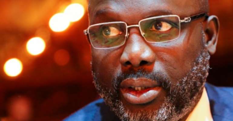 Speculation had been growing that President George Weah would exploit a December 8 constitutional referendum to extend his stay in office. By ludovic MARIN (POOL/AFP/File)