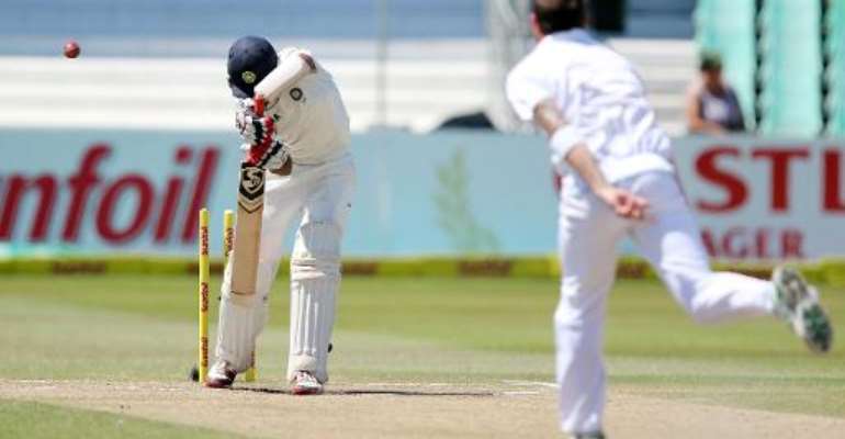 Cheteshwar Pujara (left) is clean bowled by Dale Steyn in Durban on December 30, 2013. By Anesh Debiky (AFP)