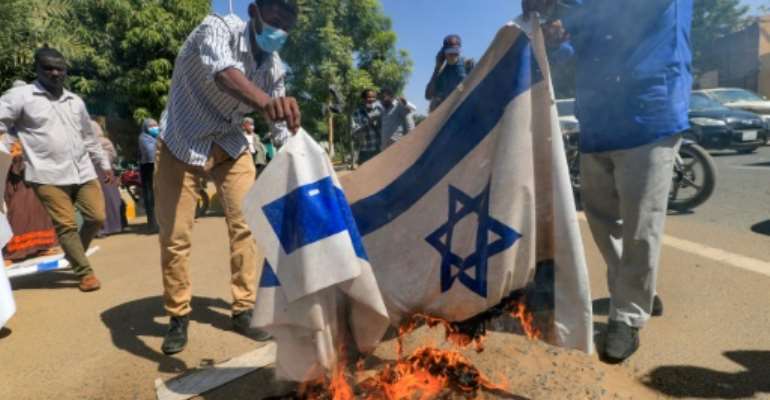 Sudanese demonstrators burned an Israeli flag during a rally against their country's recent signing of a deal on normalising relations with the Jewish state. By ASHRAF SHAZLY (AFP)