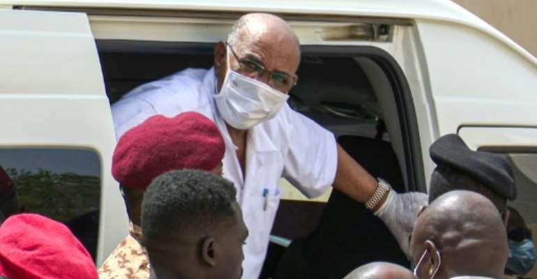 Sudan's ousted president Omar al-Bashir gets out of a car to attend his trial at a Khartoum court in this AFPTV image. By Mohammed ABUAMRAIN (AFP)
