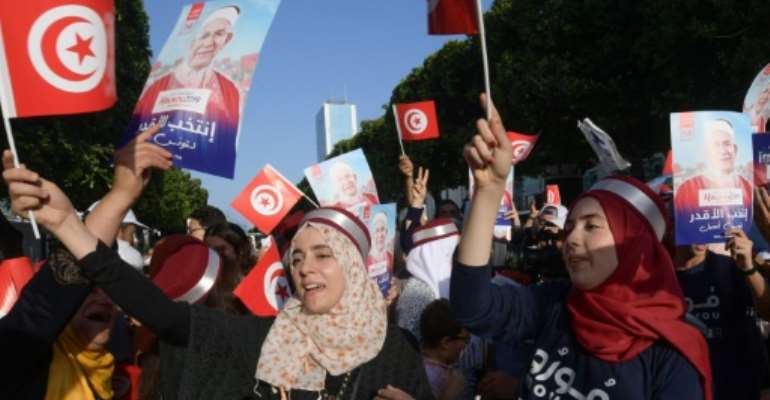 Supporters of Ennahdha candidate Abdelfattah Mourou attend an event on Thursday, as campaigning came to a close in Tunisia's presidential poll. By FETHI BELAID (AFP/File)
