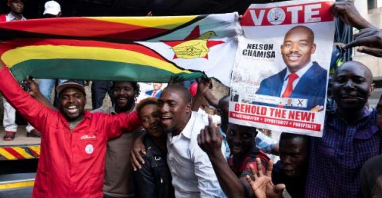 Supporters of opposition presidential candidate Nelson Chamisa were buoyant Tuesday but authorities warned vote counting would likely take several more days to complete. By MARCO LONGARI (AFP)
