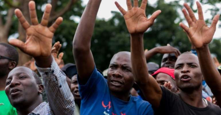Supporters of Zimbabwe opposition leader Morgan Tsvangirai take part in a Harare rally by the main opposition parties calling for free and fair elections next year. By Jekesai NJIKIZANA (AFP)