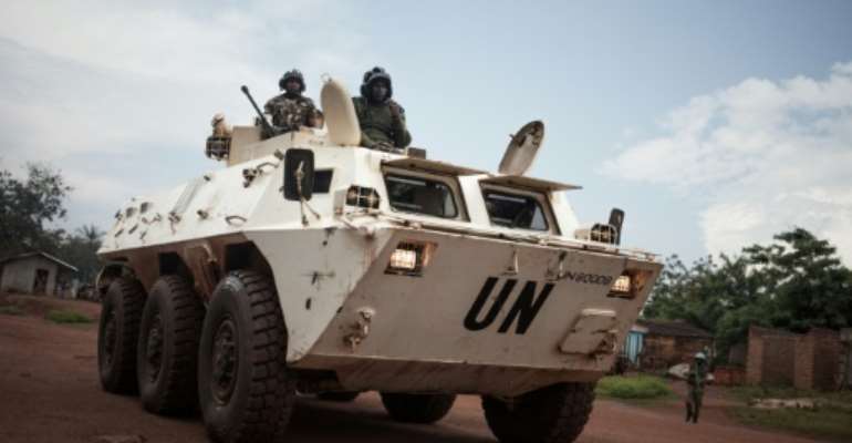 Tanzanian soldiers from the UN peacekeeping mission patrol a town threatened by the Siriri group of Fulani cattle herders. By FLORENT VERGNES (AFP/File)