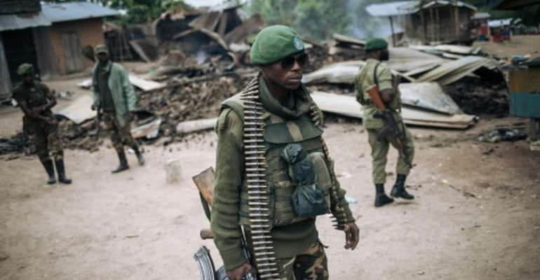 The ADF are blamed for a slew of attacks in the country's troubled east -- here, troops carry out a foot patrol after an attack near Beni last year. By Alexis Huguet (AFP/File)