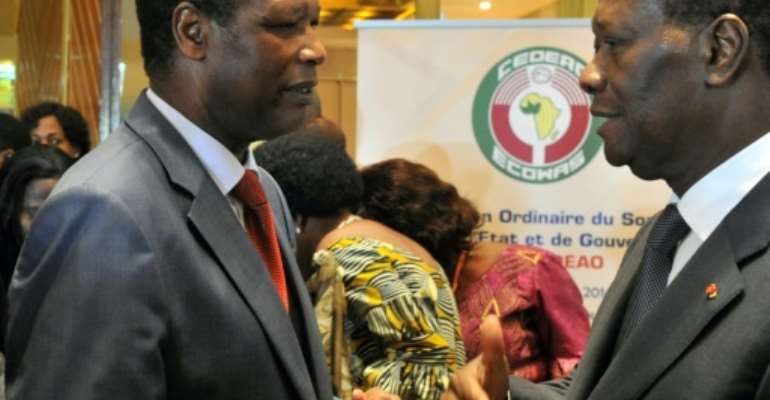 The African Union's former envoy on Mali, Pierre Buyoya, pictured left at a West African summit in Ivory Coast in March 2014. To the right is Ivorian President Alassane Ouattara. By ISSOUF SANOGO (AFP)